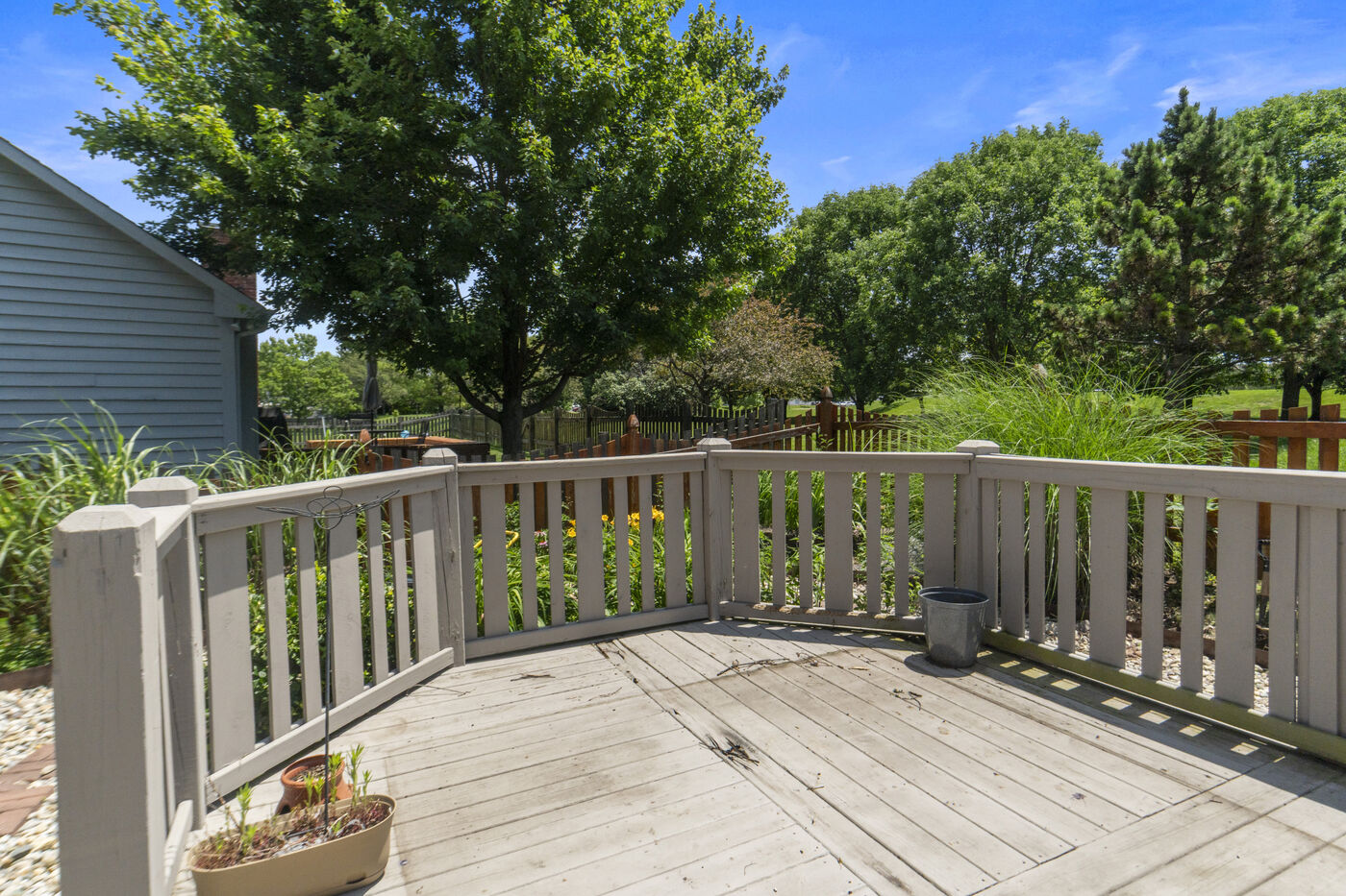 Main-level deck overlooking fenced yard