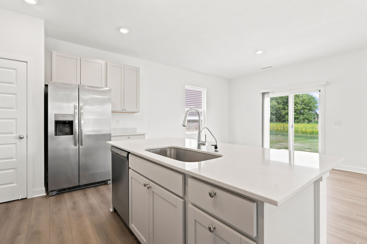 Kitchen island and stainless refrigerator