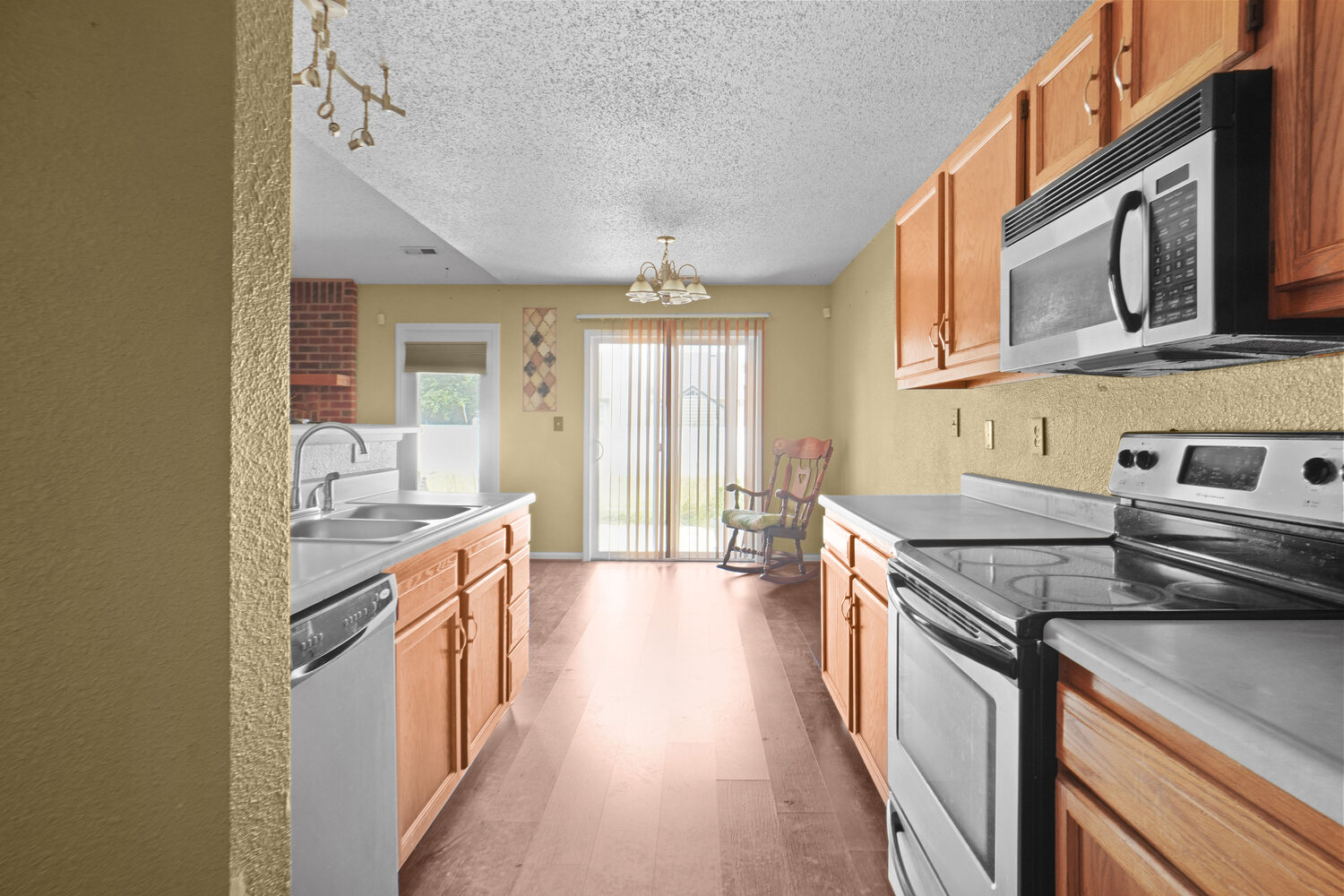Kitchen with stainless appliances open to the living space
