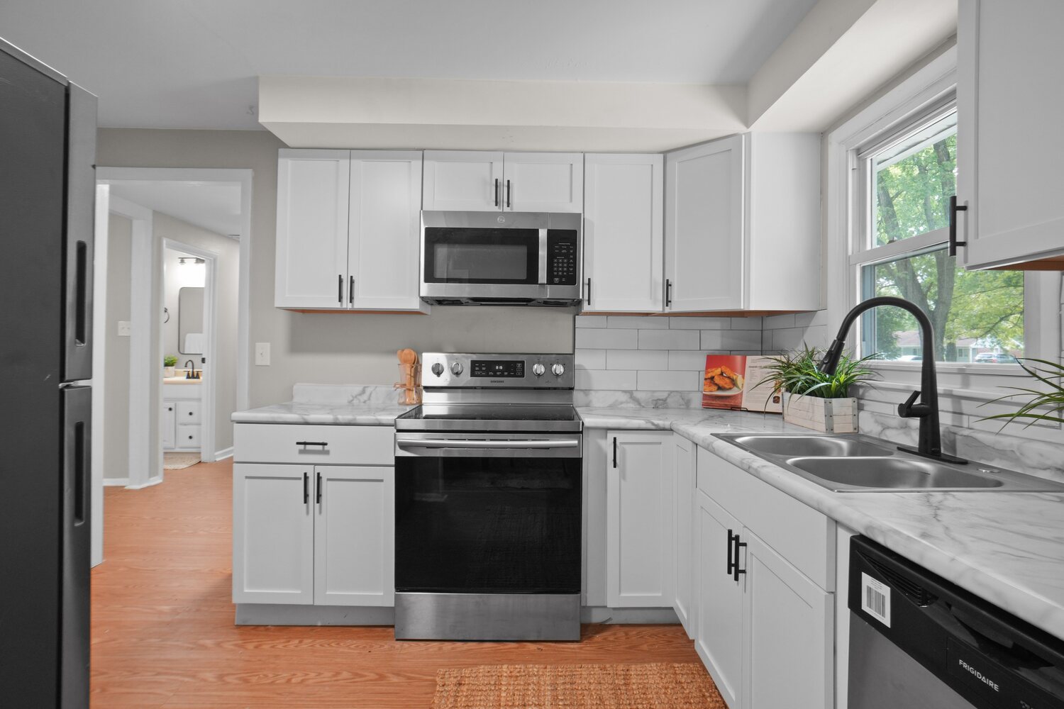 Updated white shaker kitchen with stainless appliances
